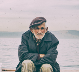 sad old man sit sea